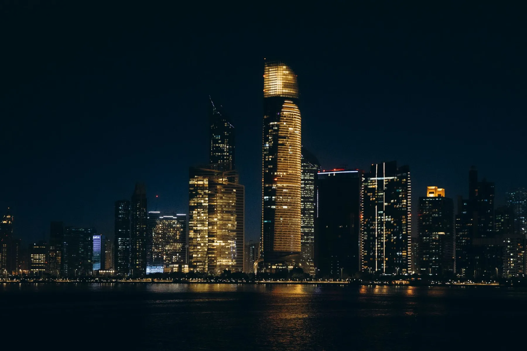Abu Dhabi skyline and waterfront at night — location photography
