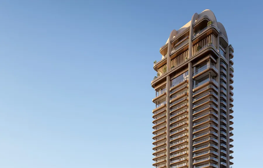 The tower façade with vertical fins and deep terraces against the Abu Dhabi sky